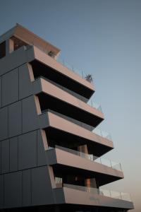 a building with balconies on the side of it at Laguna Faro Suites - Adults Only & Free Beach in Grado