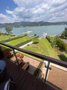 a view of the water from the balcony of a house at Wörthersee Appartements Lex in Maria Wörth