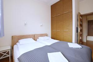 Posteľ alebo postele v izbe v ubytovaní Victus Apartamenty, Apartament Faro