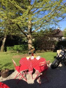 a table with a red and white polka dot table cloth at Gites Graines du Jura in Chille