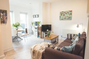 a living room with a couch and a table at Waves - Duplex Apartment Stoke Fleming in Stoke Fleming