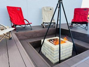 two chairs and a fire pit on a patio at Koti + Yamanakako in Yamanakako +13 photos