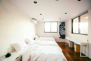 Un pat sau paturi într-o cameră la Koti + Yamanakako