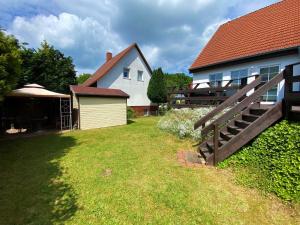 a house with a yard with a wooden fence at Ferienhaus Ruegenliebe 01 in Binz