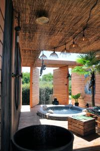 a patio with a jacuzzi tub in a yard at La Parenthèse in Bergerac