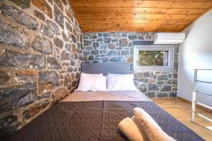 מיטה או מיטות בחדר ב-TerraZeus - Stone House Beachfront 1