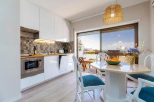a kitchen and dining room with a table and chairs at Ocean view apartment in Portimão