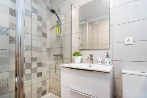 a bathroom with a sink and a shower at Ocean view apartment in Portimão +19 photos