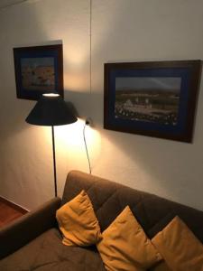 a living room with a couch and a lamp at Casa da Ti Gorda Alojamento Local Monsaraz - Alentejo - Portugal in Reguengos de Monsaraz