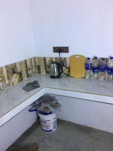 a counter with a lot of bottles of water at Joes resthouse in Oddaimavadi