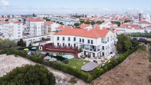an aerial view of a large white building with a red roof at Hotel Dom Vasco in Sines