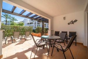 a patio with a table and chairs on a patio at Nice Groundfloor Apartment - BO202LT in Torre-Pacheco