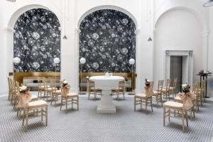 a dining room with a table and chairs and a wall at Rosselli AX Privilege in Valletta