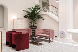 a living room with two chairs and a staircase at Rosselli AX Privilege in Valletta