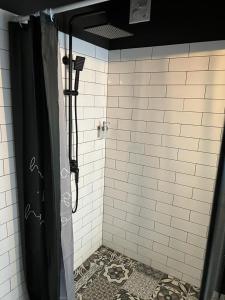 a shower with a black shower curtain in a bathroom at 4 STARS ROOMS Near Airport in Ščitarjevo