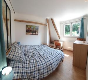a bedroom with a bed with a plaid blanket at Gites de charme centre de 2 à 8P, jardin, parking, durable in Honfleur