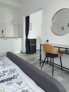a room with a bed and a table and a chair at Apartman LUCIJA in Korčula