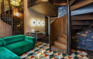 a green couch in a room with a staircase at Rosselli AX Privilege in Valletta