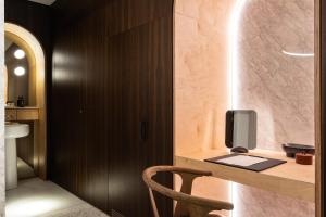 a room with a desk with a tv and a chair at Rosselli AX Privilege in Valletta