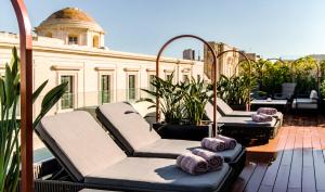 a row of chaise lounges on a balcony at Rosselli AX Privilege in Valletta