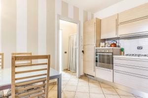 a kitchen with a table and a stove top oven at Residenza Liliana in Busto Arsizio +13 photos