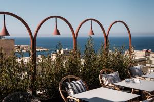 a view of the ocean from a restaurant with tables and chairs at Rosselli AX Privilege in Valletta