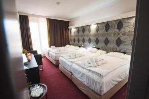Voodi või voodid majutusasutuse Wellness hotel Lucia toas