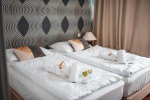 Voodi või voodid majutusasutuse Wellness hotel Lucia toas