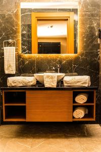 a bathroom with a sink and a mirror at Aselia Hotel Trabzon in Trabzon +64 photos