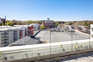 a view of a building with a parking lot at Forenom Hotel Flemingsberg - 10min from Älvsjö in Huddinge