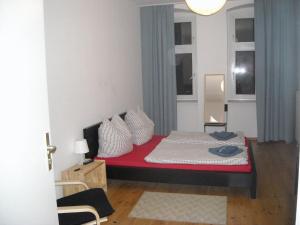 una camera da letto con un letto con cuscini rossi e bianchi di Pension Mitte a Berlino
