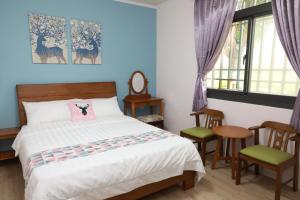 Postel nebo postele na pokoji v ubytování 小葉園民宿Little Ya B&B