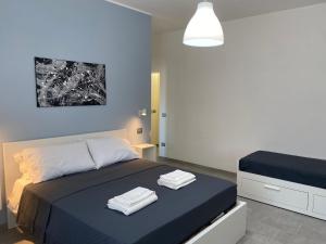 a bedroom with a bed with two towels on it at B&B 8 Marzo in Belvedere Marittimo
