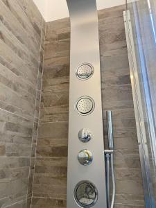 a shower stall with three circles on the wall at B&B 8 Marzo in Belvedere Marittimo +22 photos