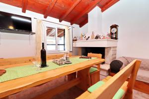 a living room with a table and a fireplace at Holiday Home Zule in Žrnovo