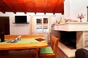 a living room with a table and a fireplace at Holiday Home Zule in Žrnovo