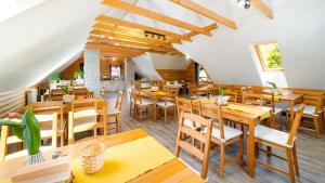 an empty restaurant with wooden tables and chairs at Wilczy Wodospad in Karpacz