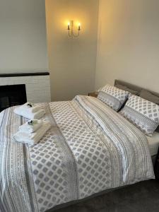 a bedroom with a bed with towels on it at Impeccable 2-Bed Apartment in Eastbourne in Eastbourne