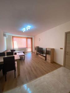 a large living room with a table and a couch at Апартамент SUMI in Varna City