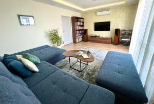 a living room with a blue couch and a table at Apartment Maslina in Makarska
