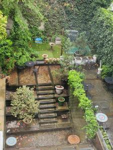 a garden with a table and some potted plants at Chelsea Pines Inn in New York