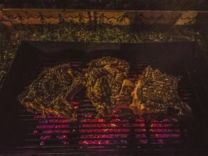 a rack of meat cooking on a grill at National monument Mehmedbasica Kuca in Stolac