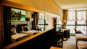 a hotel room with two beds and a couch at Aselia Hotel Trabzon in Trabzon