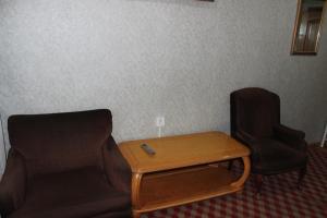 two chairs and a table in a room at City Hostel & Tours in Ulaanbaatar
