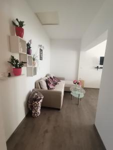 a living room with a couch and a table at Apartman Sunset in Sutomišćica