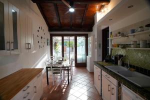 a kitchen with a table and a dining room at Villa Piri in Sabaudia