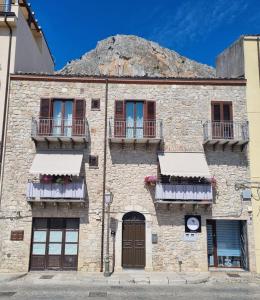 an old stone building with windows and balconies at VeraLuce in Caltavuturo