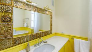 a bathroom with a sink and a large mirror at Villa Guidi 10 Emma Villas in Milano Marittima +55 photos