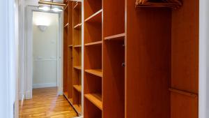 a closet with wooden shelves in a room at Villa Guidi 10 Emma Villas in Milano Marittima