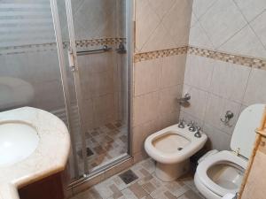 y baño con ducha, aseo y lavamanos. en Rosario Departamentos en Rosario